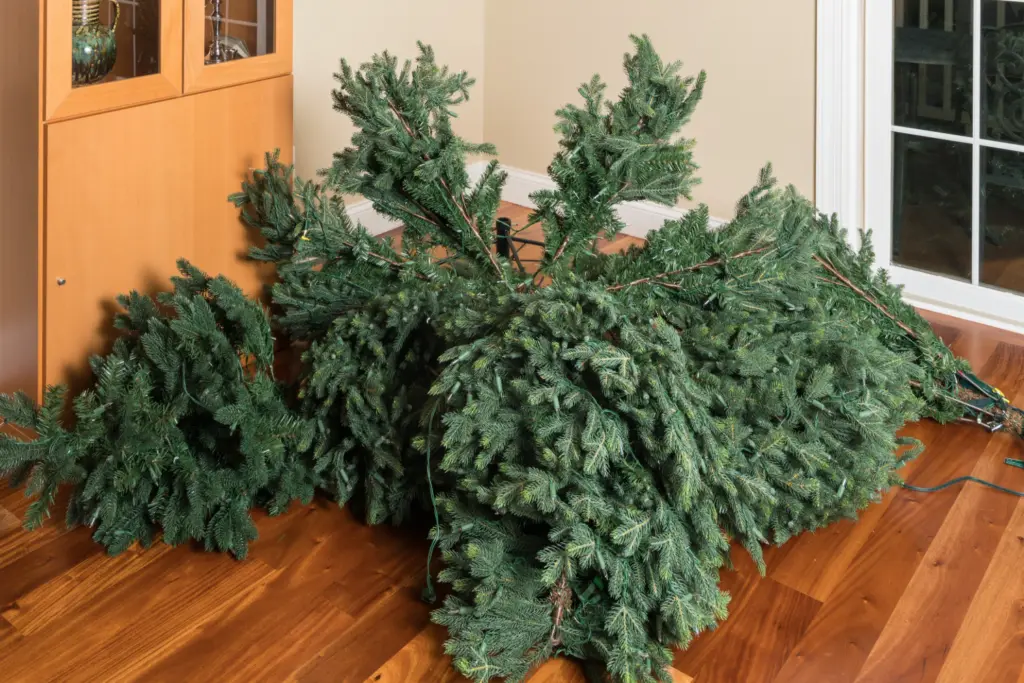 sections of pre lit christmas tree lay out on floor