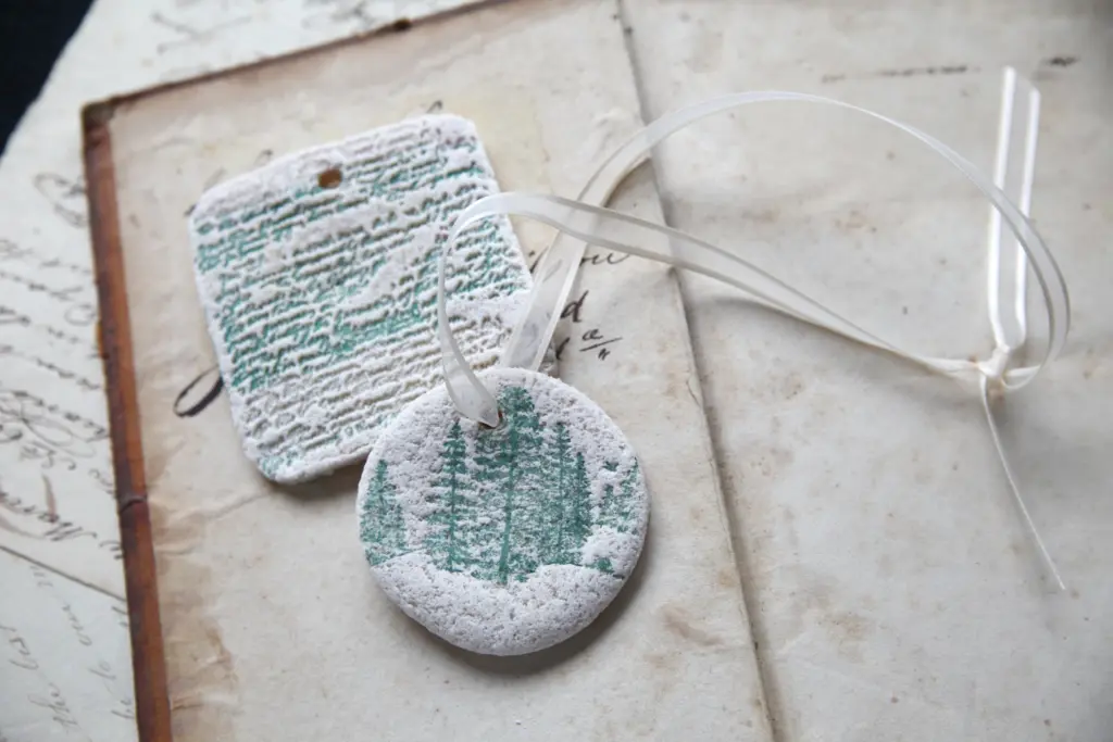 hand made salt dough ornaments with white chalk paint and green tree and word impressions