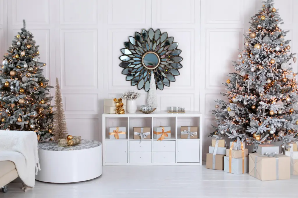 minimalist christmas decorating on bookcase in between two Christmas trees